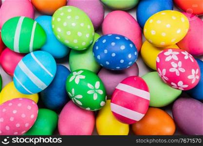 Beautiful background of many colorful easter eggs top view. Many colorful easter eggs