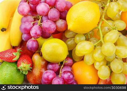 Beautiful background of ripe fruits. Organic healthy food.. Bright beautiful background of ripe fruits. Organic healthy food.