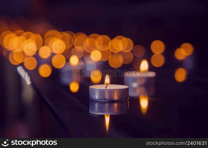 beautiful background with candles. Light in the dark