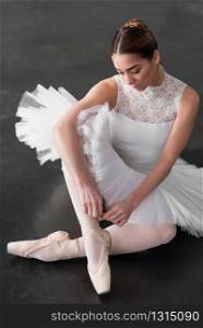 Beautiful ballerina posing in ballet class, barre and white wall on background. Beautiful ballerina posing in ballet class