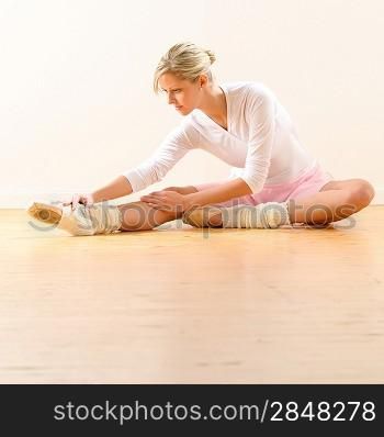 Beautiful ballet dancer stretching in the studio woman ballerina exercise