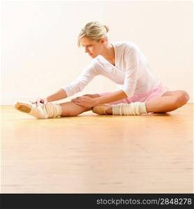 Beautiful ballet dancer stretching in the studio woman ballerina exercise