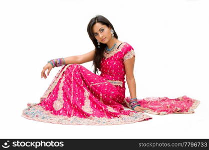 Beautiful Bangali bride in colorful dress sitting, isolated