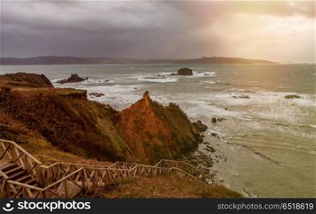 Beautiful beach and amazing cliff . Beautiful beach and amazing cliff with wooden stairs