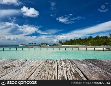 Beautiful beach and old wooden pier at Maldives