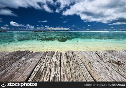Beautiful beach and old wooden pier at Seychelles
