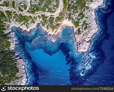 Beautiful beach and rocky coastline top aerial view drone shot, Sithonia, Greece