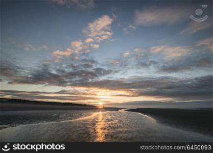 Beautiful beach coastal landscape image at sunrise with colorful vibrant sky