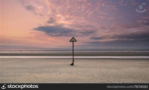Beautiful beach coastal landscape image at sunrise with colorful vibrant sky