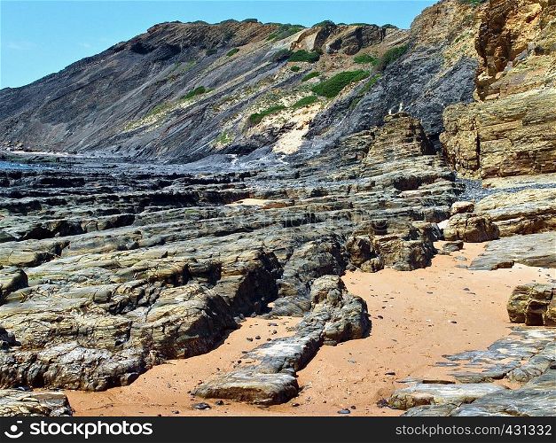 Beautiful beach in Odeceixe in Portugal with interesting slate rocks