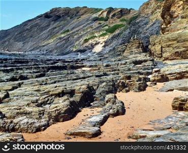 Beautiful beach in Odeceixe in Portugal with interesting slate rocks