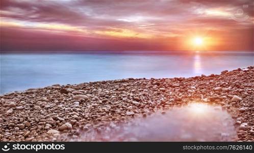 Beautiful beach landscape, amazing view on pebble coast in mild sunset light, wonderful place for romantic holidays, beauty of nature