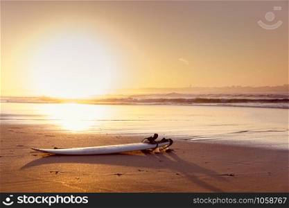 Beautiful beach lansdscape with a surfboard in the sand