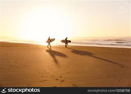 Beautiful beach lansdscape with surfers ready to hit the waves