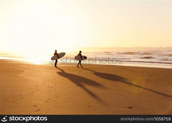 Beautiful beach lansdscape with surfers ready to hit the waves