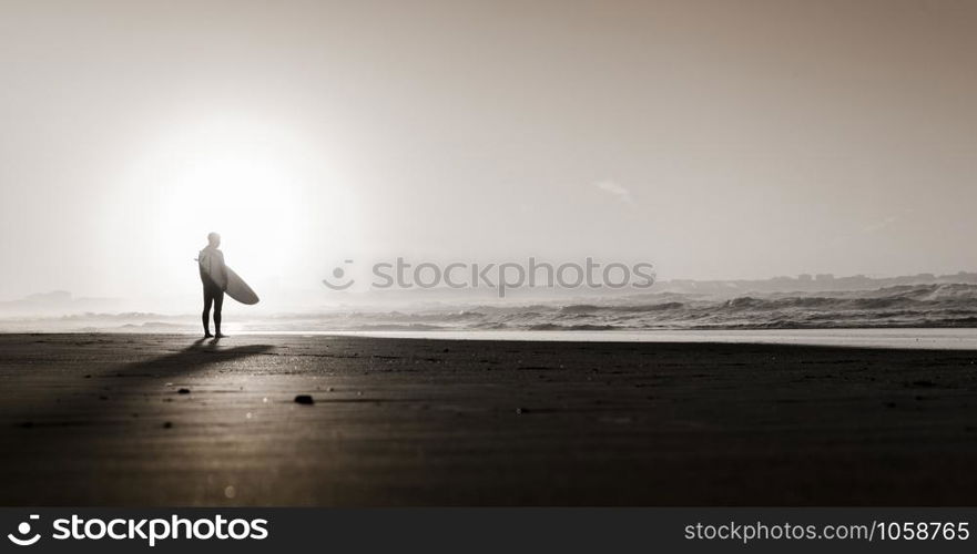 Beautiful beach lansdscape with surfers ready to hit the waves