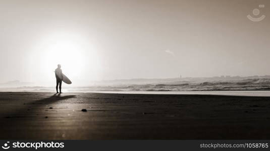 Beautiful beach lansdscape with surfers ready to hit the waves