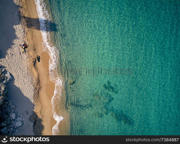 Beautiful beach with family top aerial view drone shot, Sithonia, Greece