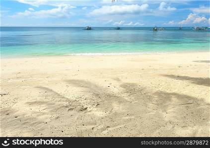 Beautiful beach with palm trees shadow at Philippines