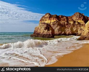 Beautiful beach with rocky cliffs in Portimao at the Algarve coast of Portugal