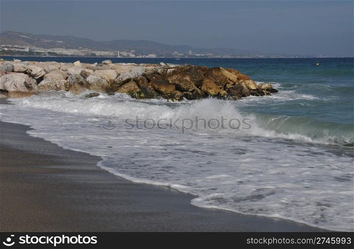 beautiful beach with stone pier in Puerto Banus (Marbella), Spain