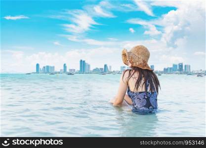 Beautiful beaches and blue skies in summer with women sitting on the beach.