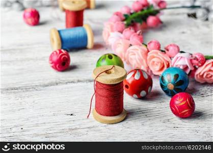 Beautiful beads and spool of thread. Round beads for making jewelry and spools of thread in bright tone