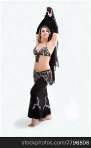 Beautiful belly dancer in black outfit holding veil, isolated