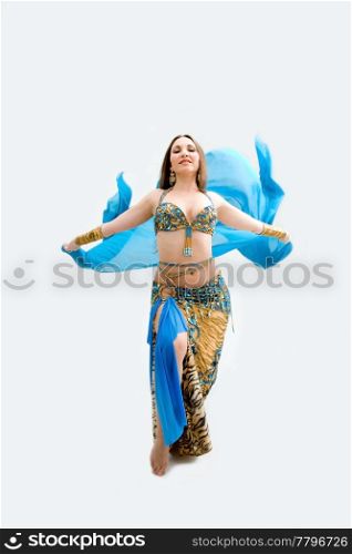 Beautiful belly dancer in blue outfit holding veil, isolated
