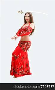 Beautiful belly dancer in red outfit balancing sword, isolated