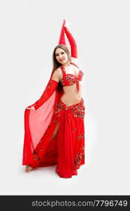 Beautiful belly dancer in red outfit holding veil, isolated