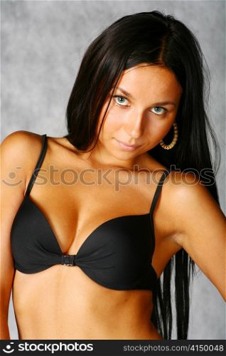 beautiful bikini girl isolated over a gray background