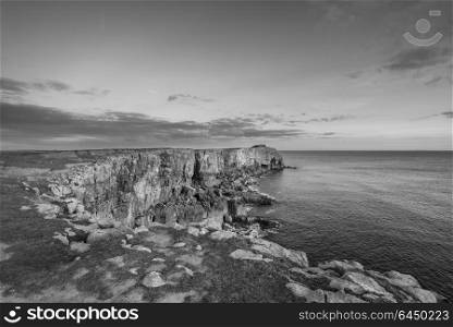 Beautiful black and white landscape image of cliffs around St Govan&rsquo;s Head on Pembrokeshire Coast in Wales