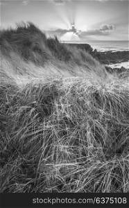 Beautiful black and white landscape image of Freshwater West beach with sand dunes in Pembrokeshire Wales