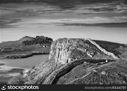 Beautiful black and white landscape image of Hadrian&rsquo;s Wall in N. Stunning black and white landscape image of Hadrian&rsquo;s Wall in Northumberland at sunset with fantastic late Spring light