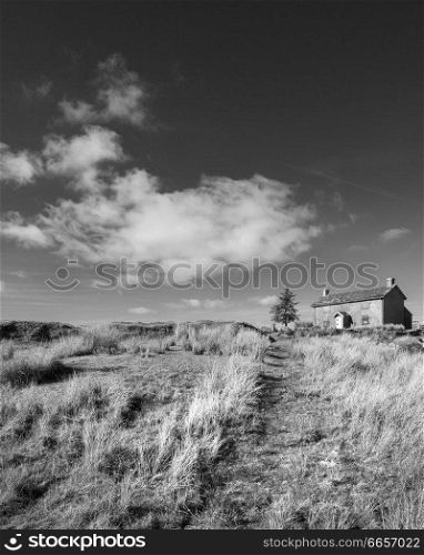Beautiful black and white landscape image of Nun&rsquo;s Cross Farm in Dartmoor