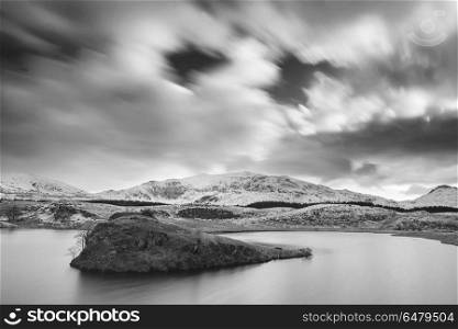 Beautiful black and white long exposure Winter landscape image . Beautiful black and white Winter landscape image of Llyn y Dywarchen in Snowdonia National Park