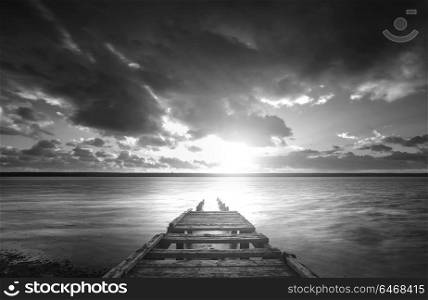 Beautiful black and white sunset landscape image of Fleet Lagoon in Dorset England