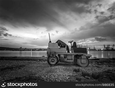 Beautiful black and white view at small roller at a construction site in a beautiful twilight