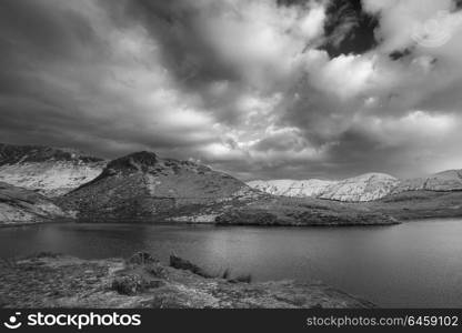 Beautiful black and white Winter landscape image of Llyn y Dywarchen in Snowdonia National Park