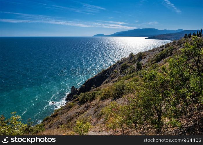 Beautiful Black Sea landscape with a steep rocky shore on a summer sunny day, Crimea.
