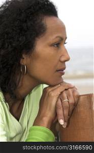 Beautiful black woman looking out over sea