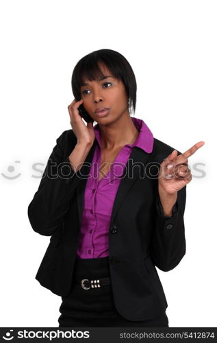 beautiful black woman on the phone pointing sideways