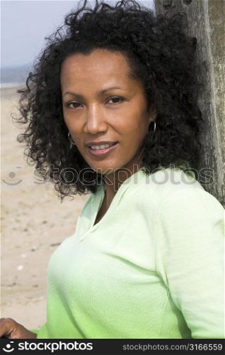 Beautiful black woman outdoors enjoying a day at the beach