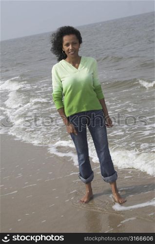 beautiful black woman standing by the waterside