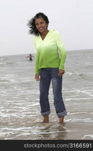 Beautiful black woman standing in the sea