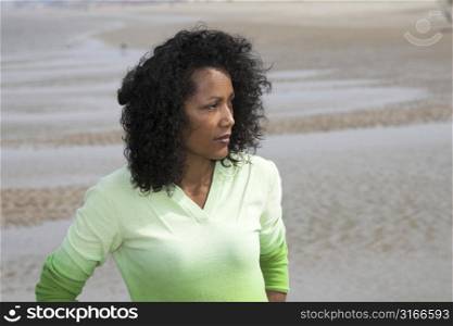 Beautiful black woman staring out over the sea