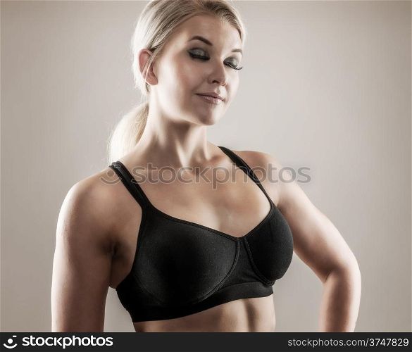 Beautiful blond fitness woman on good shape, desaturated studio shot