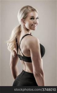 Beautiful blond fitness woman on good shape, desaturated studio shot