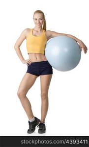 beautiful blond girl in fitness dress keeping a big gym ball isolated on white. NATURAL SKIN